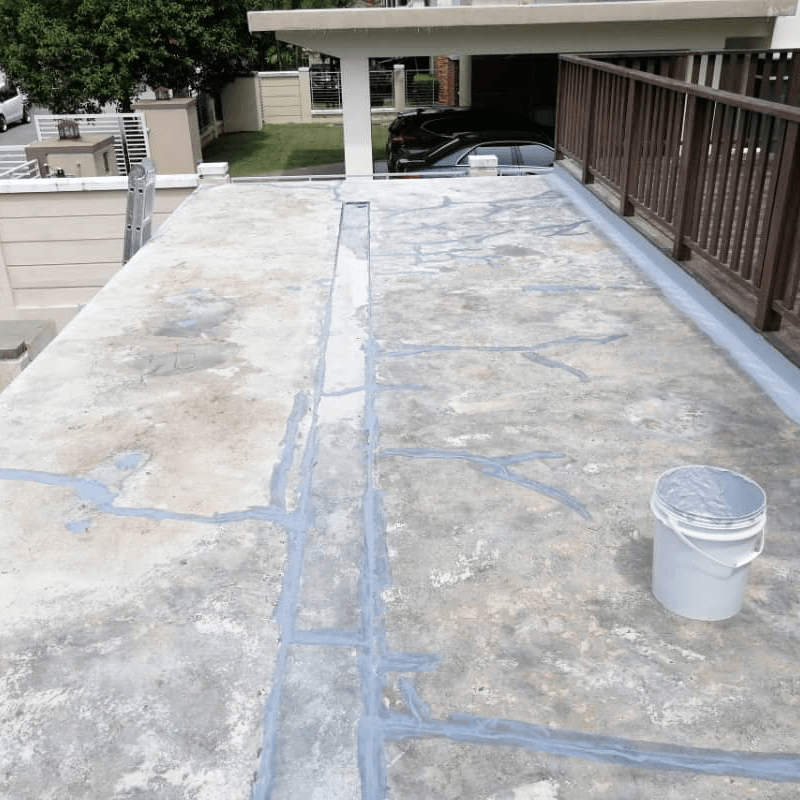 Filling up the hairline cracks on concrete flat roof with Nanotechnology Waterproofing.