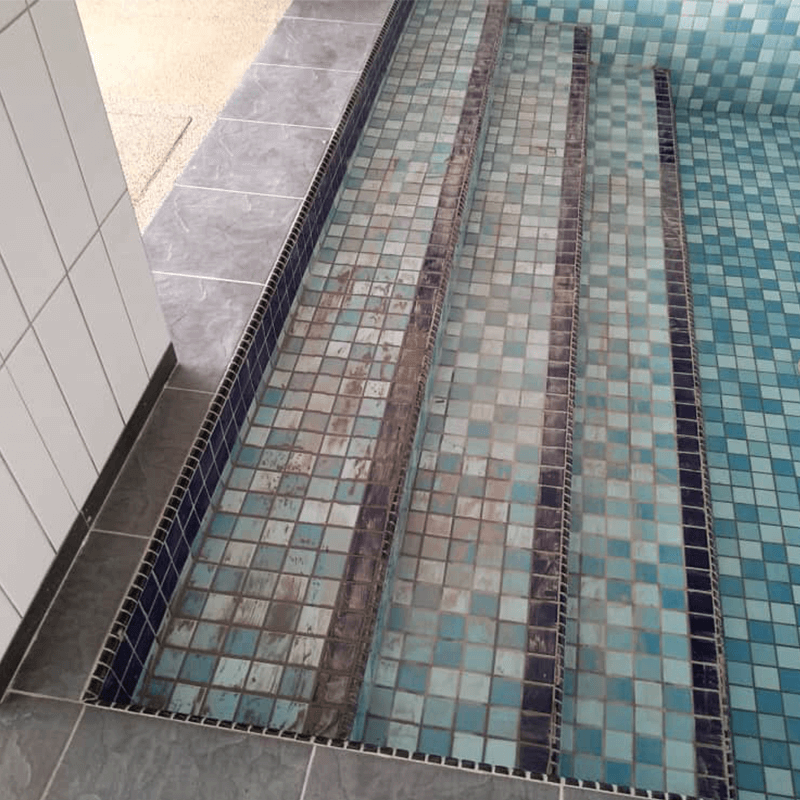 Swimming pool stairway in the process of cleanup before applying Nano-G Anti-Slip Floor Coating to provide extra grip for swimmers.