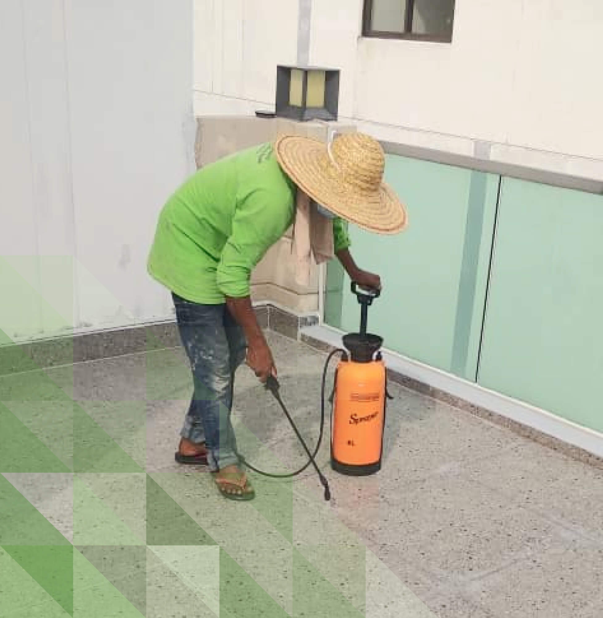 Worker using a sprayer to apply Nano-G nanotechnology waterproofing solution on a balcony.